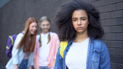 girl ignoring two bullies